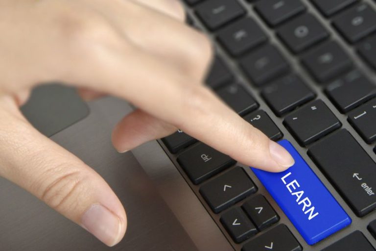 knowledge base image of person clicking Learn button on laptop