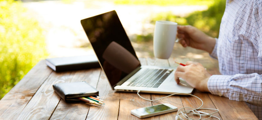 Payroll options man typing on laptop