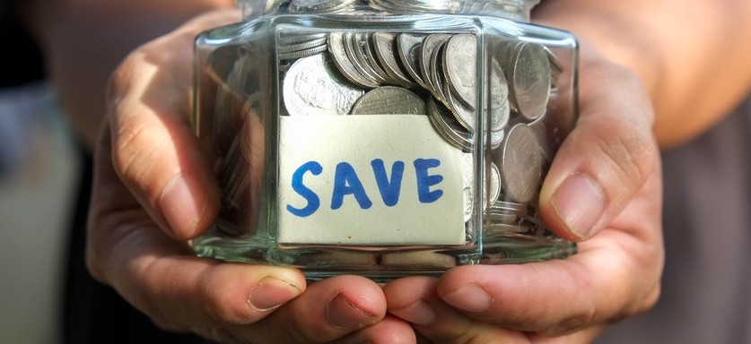 what is an ira? Person holding savings jar.