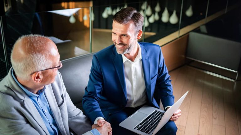 businessmen shaking hands after making a deal